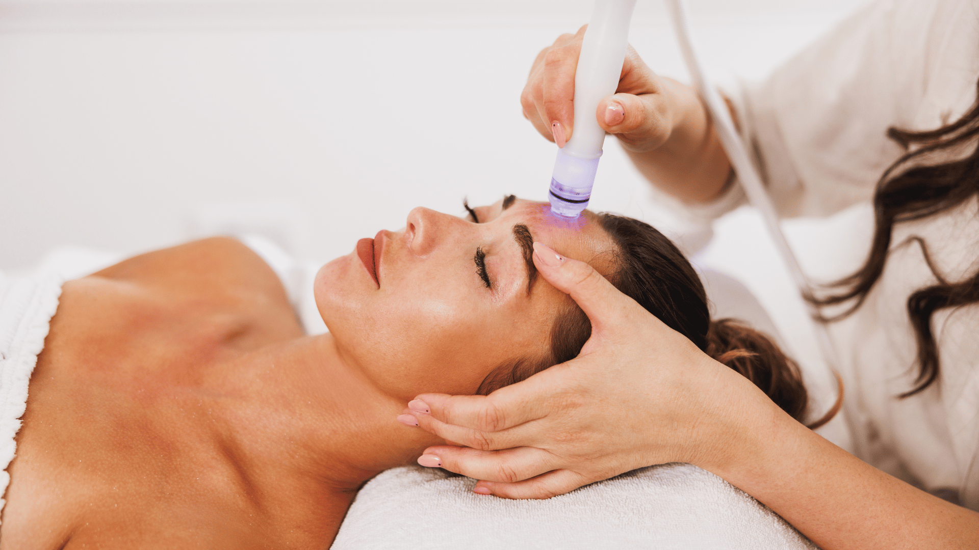 Skin treatments to try during summer; woman getting a skin treatment