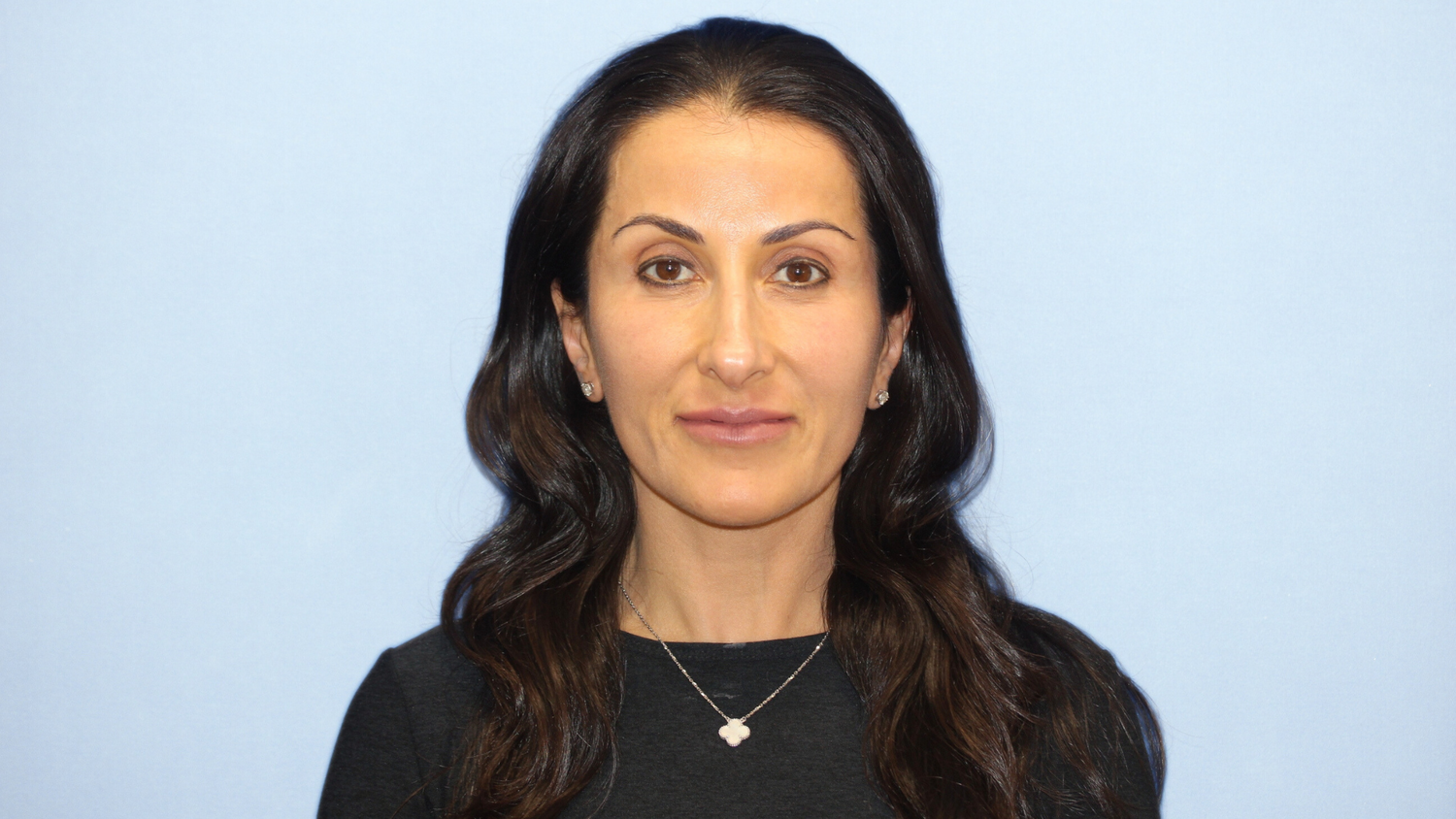 Dr. Karam's wife and patient post-surgery from a Vertical Restore, with glowing healthy skin from using the KaramMD Trifecta skincare routine.