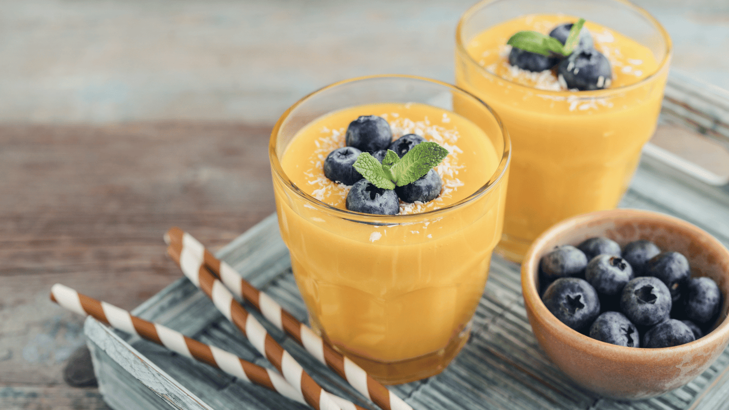 A vibrant smoothie surrounded by fresh fruits, representing Dr. Karam’s nutrient-packed recipe for healthy, glowing skin.