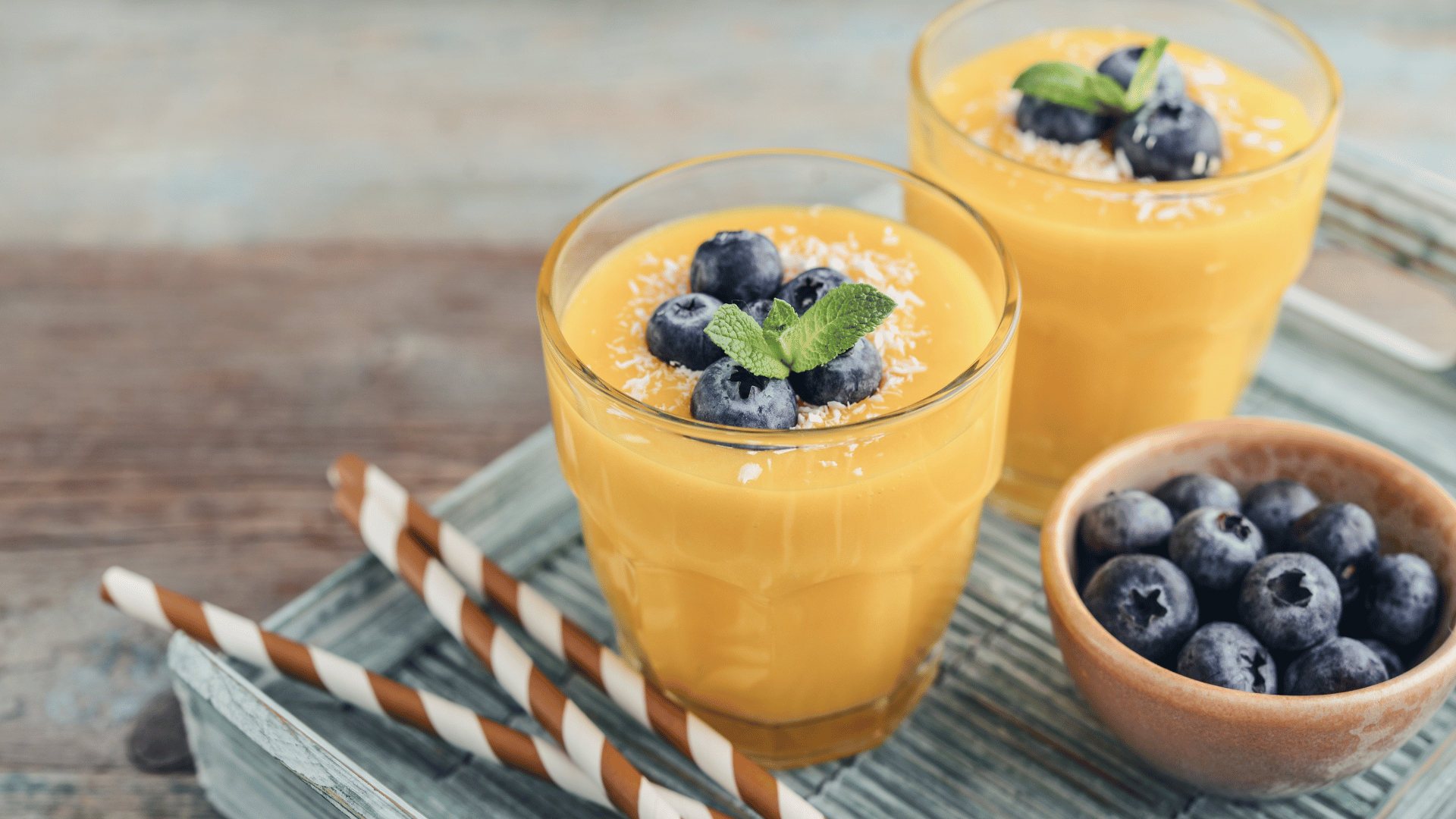 A vibrant smoothie surrounded by fresh fruits, representing Dr. Karam’s nutrient-packed recipe for healthy, glowing skin.