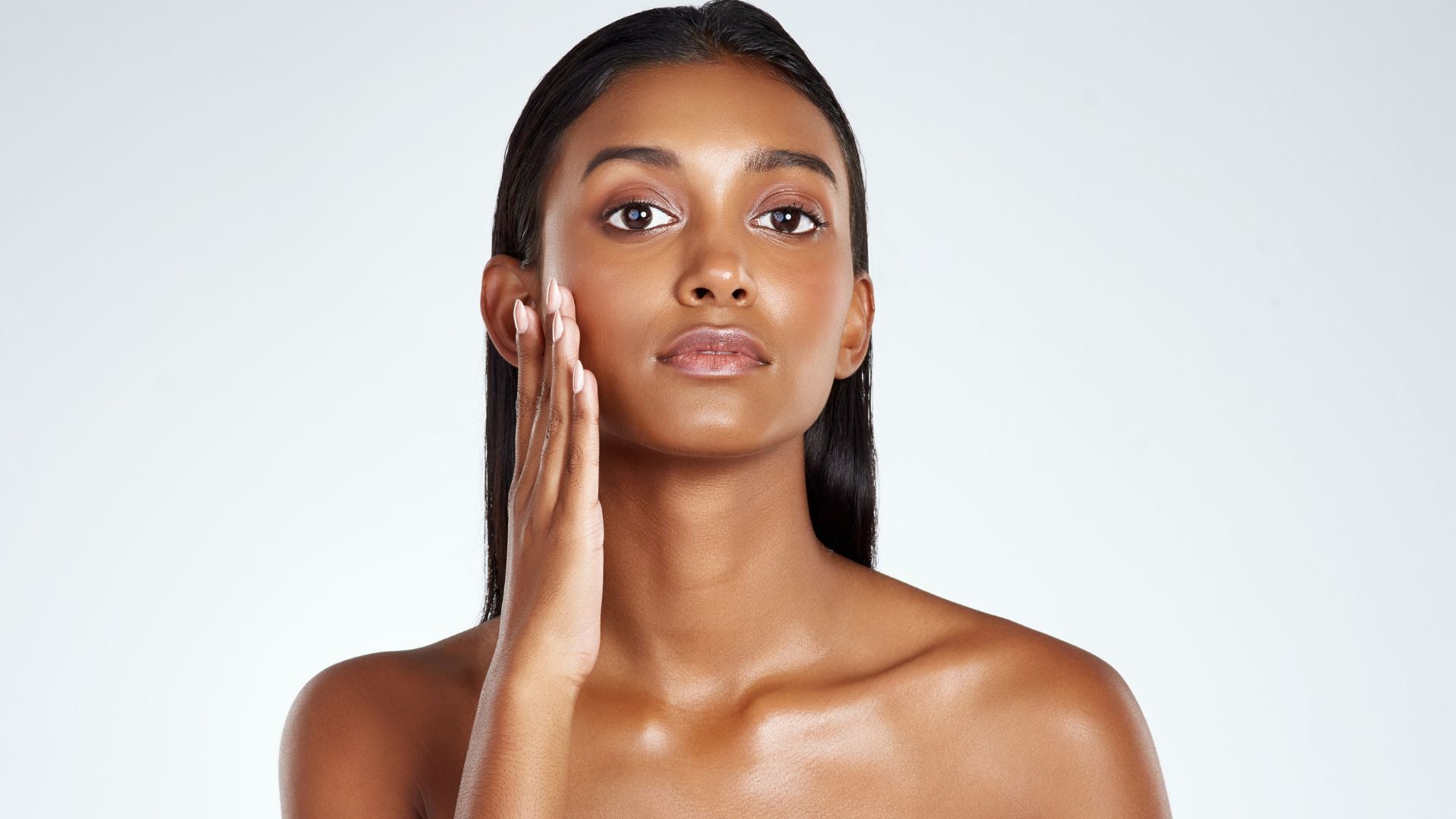Woman applying skincare oils for oily skin