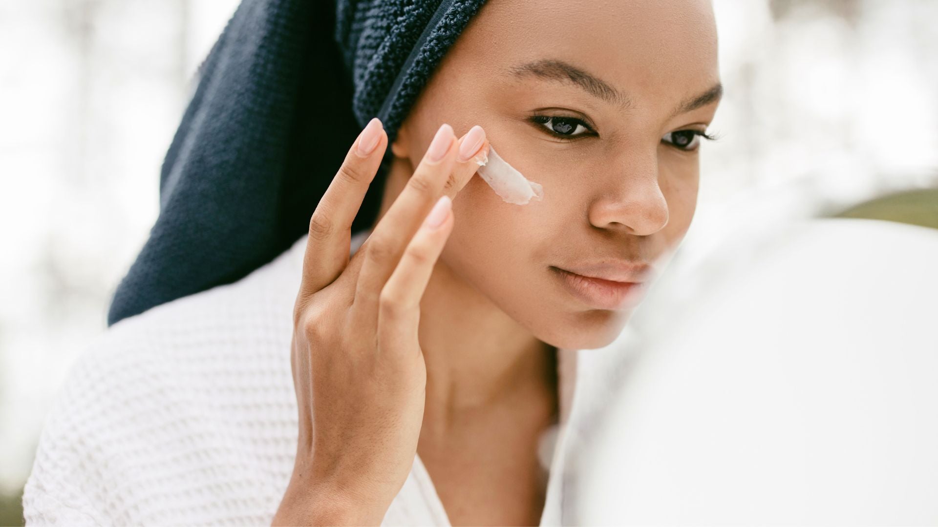 Woman applying skincare and eye cream