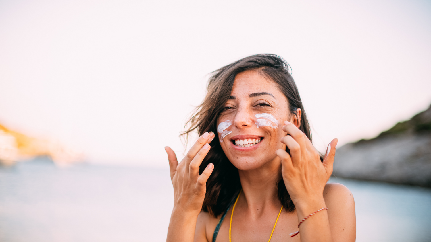 woman enjoying sunshine safely with visible application of sunscreen