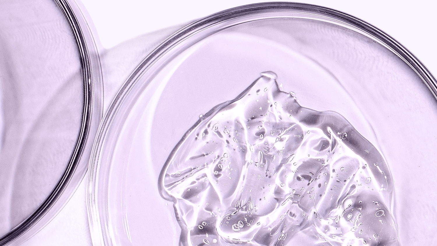 A close-up of a hydrating skincare gel texture in a petri dish, highlighting a clean, science-backed formula designed to support moisture, skin barrier health, and a refreshed complexion.