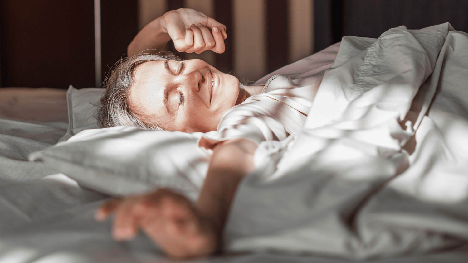 Woman waking up with a glow, skin looking youthful