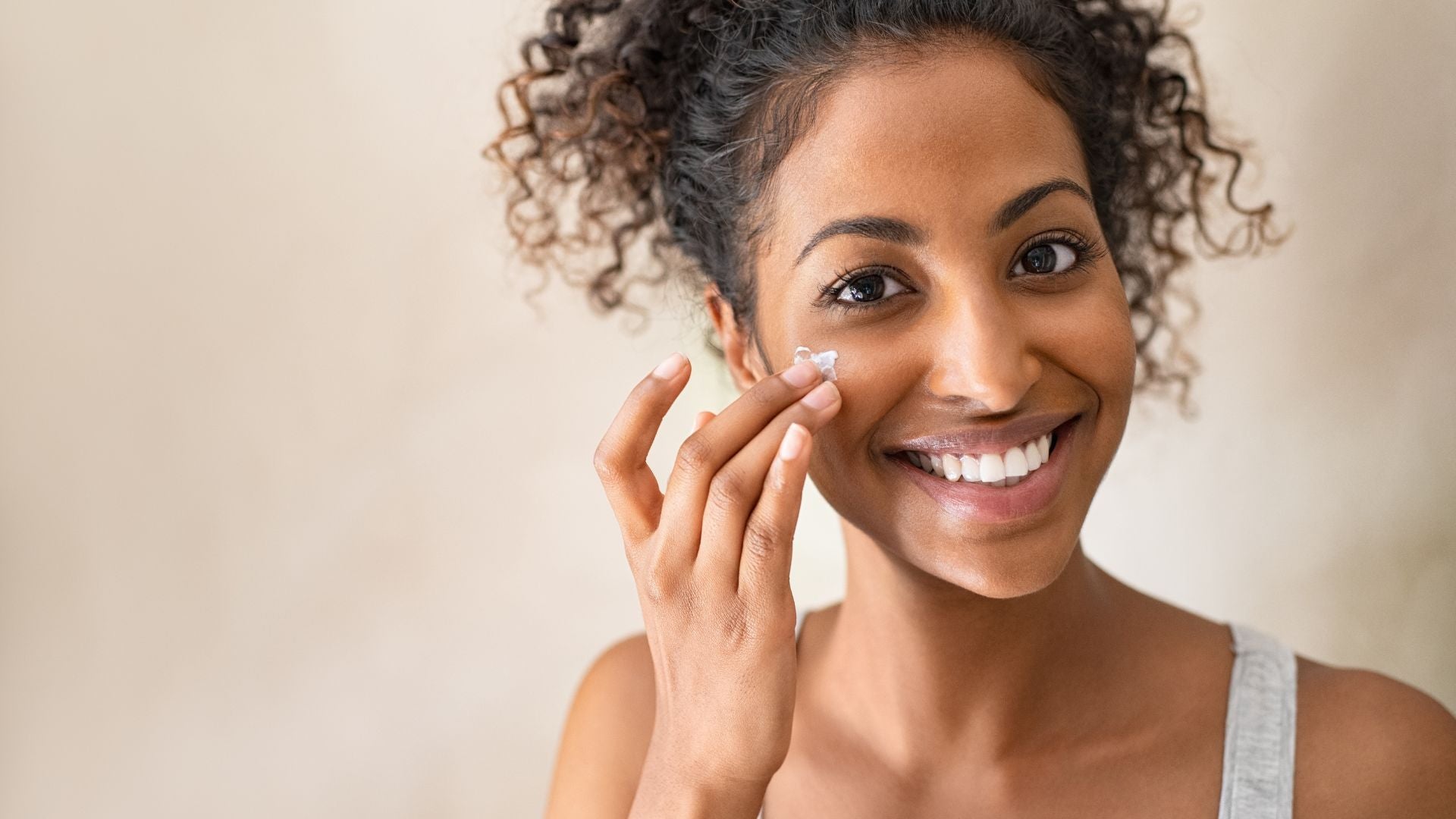 woman with smooth skin texture applying skincare product