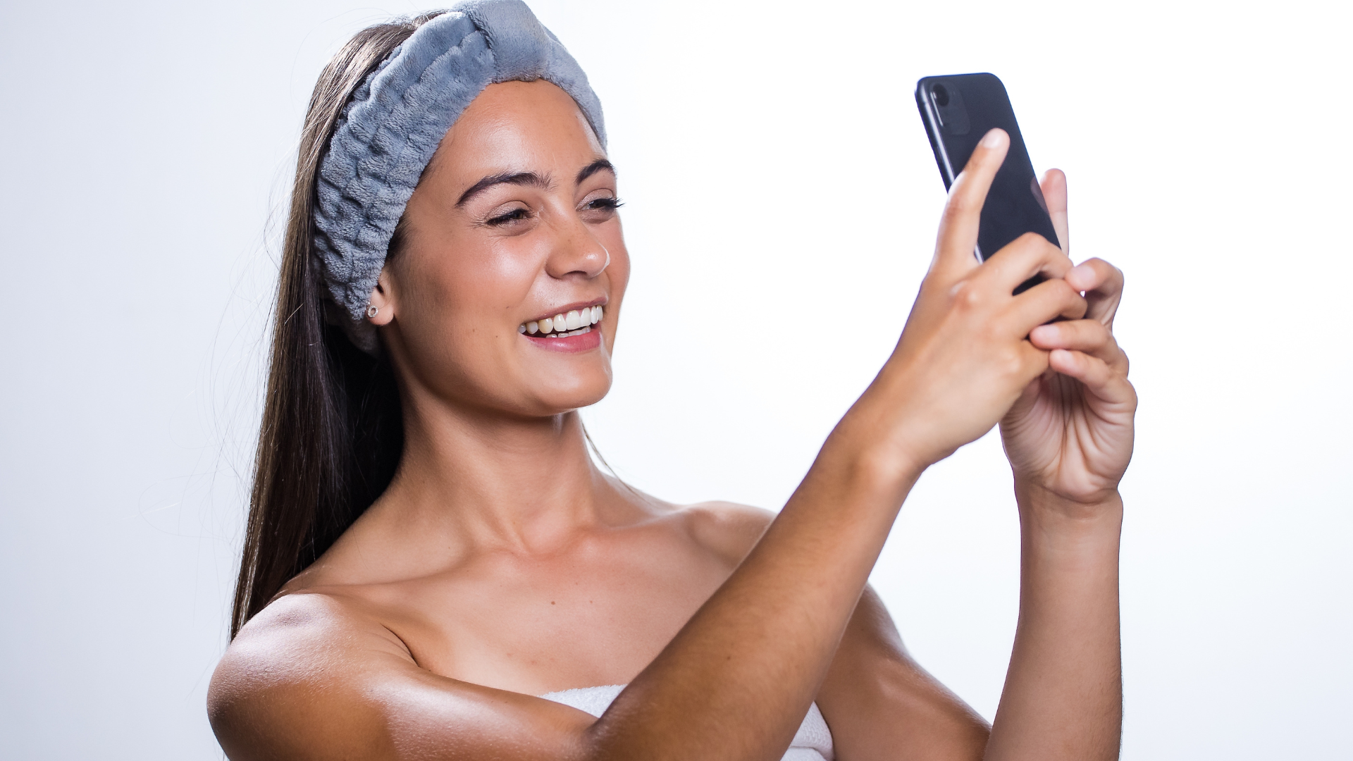 young woman taking skincare selfie