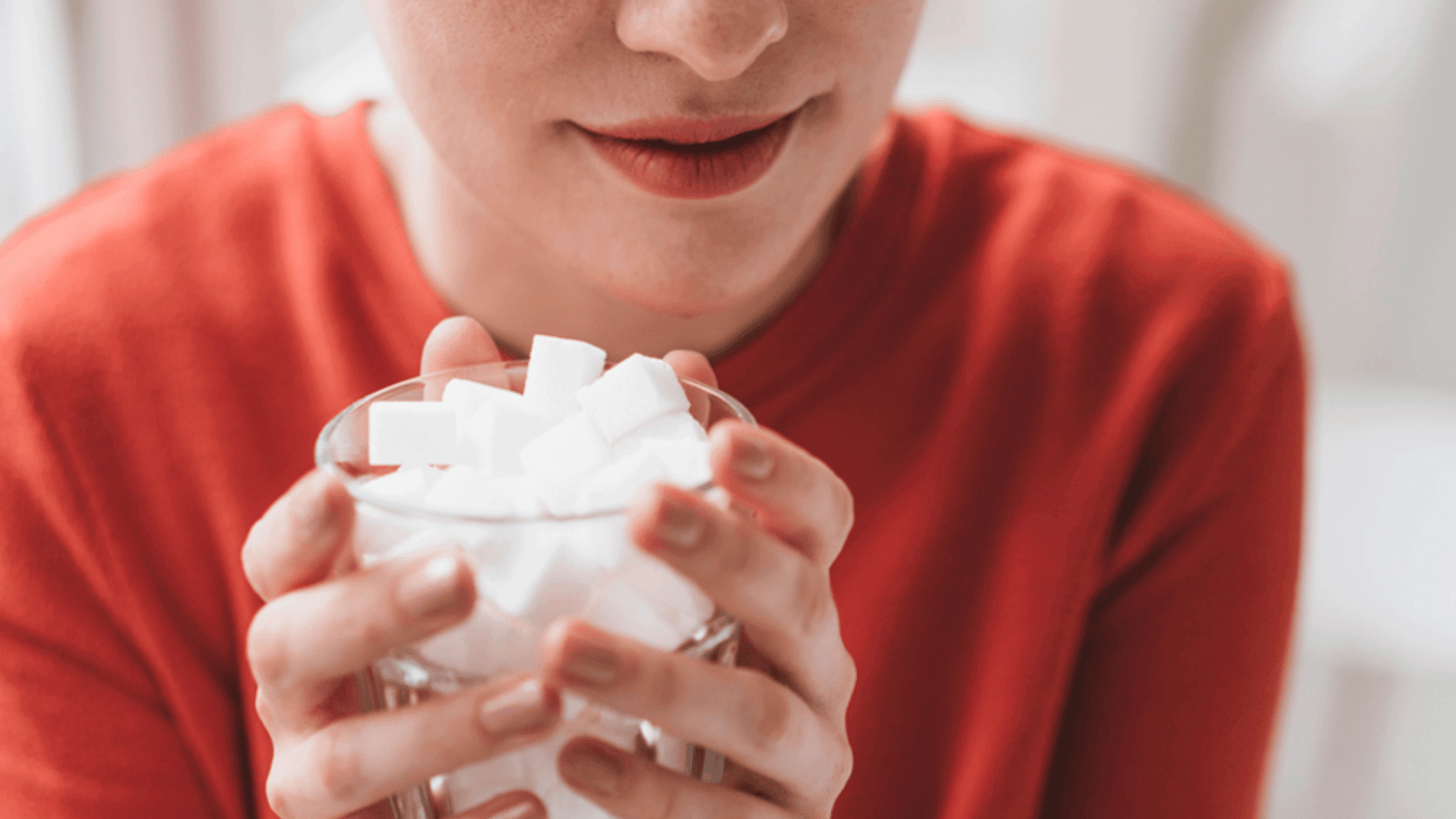 Woman holding a cup of sugar cubes