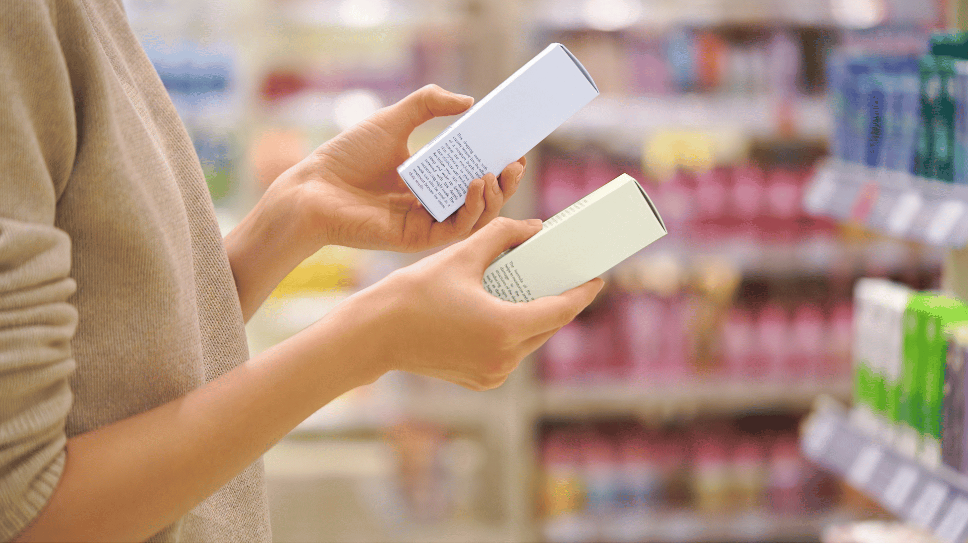 skincare shopper looking at labels on the the boxes while shopping in a beauty aisle