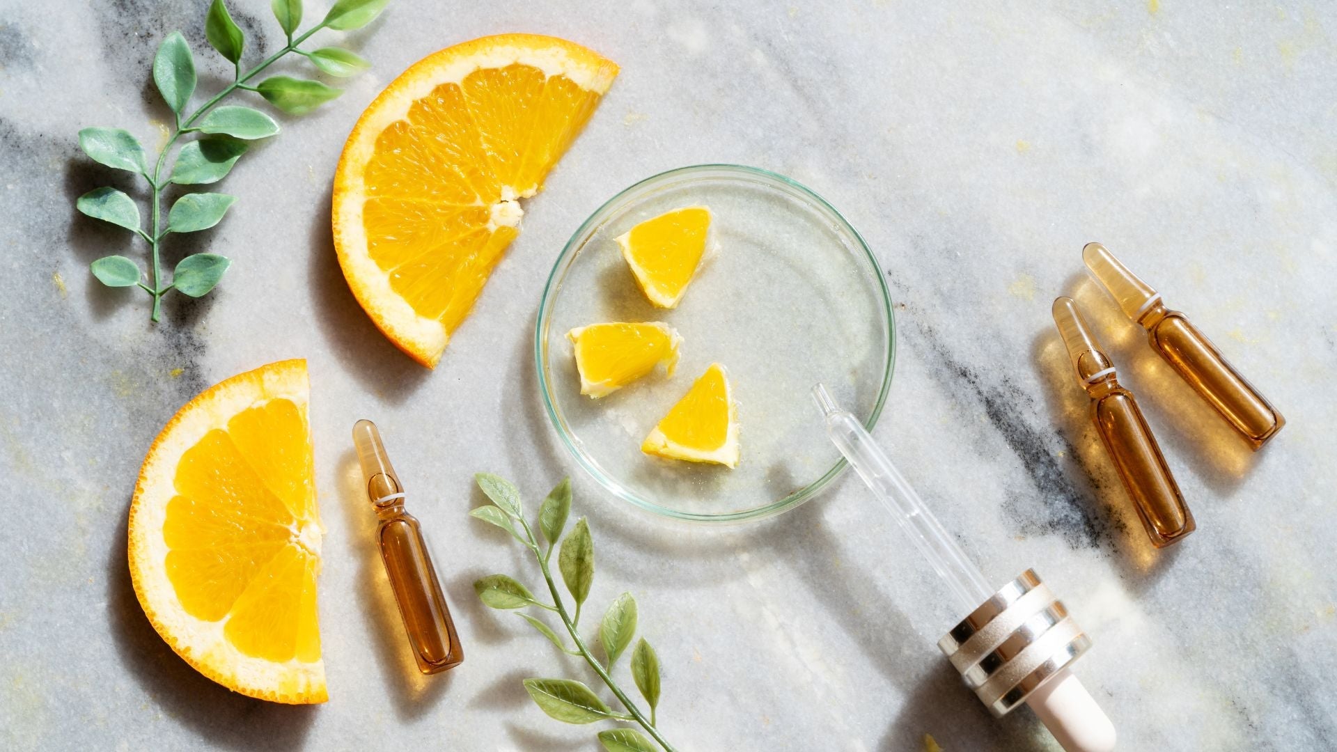 vitamin c sourced from citrus next to vials of serum