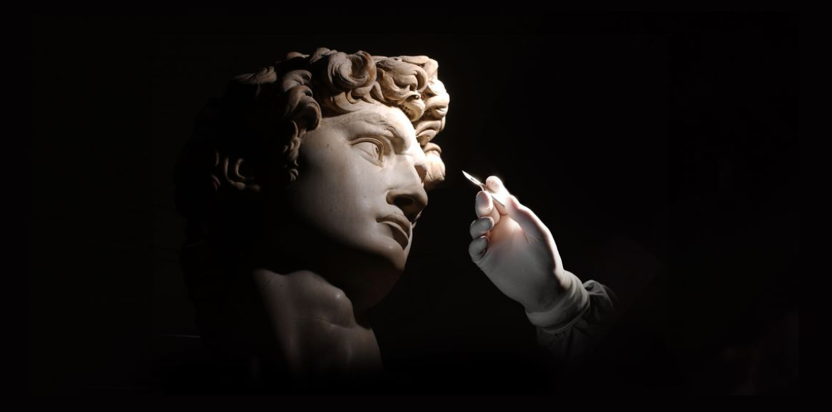 Statue of David, with gloved hand ready to inject needle for aesthetic purposes